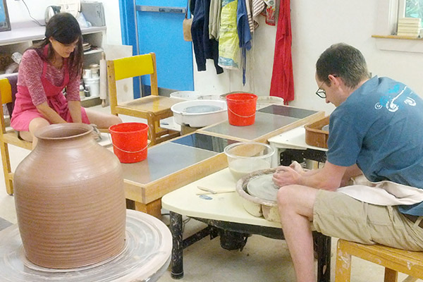 Two pottery students